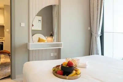 a bowl of fruit on a bed in a room at Stylish 1-Bedroom with Lake View in Business Bay in Dubai