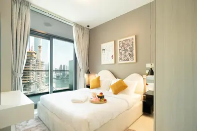 a bedroom with a white bed and a large window at Stylish 1-Bedroom with Lake View in Business Bay in Dubai