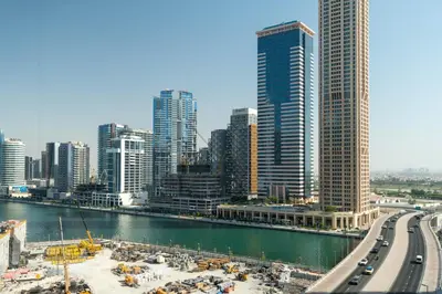 a view of a city with a river and buildings at Stylish 1-Bedroom with Lake View in Business Bay in Dubai