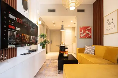 a lobby with a yellow couch and a table at Stylish 1-Bedroom with Lake View in Business Bay in Dubai