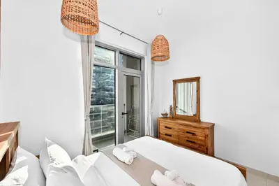 a white bedroom with a bed and a mirror at Fantastic 2 Bed - Marina in Dubai