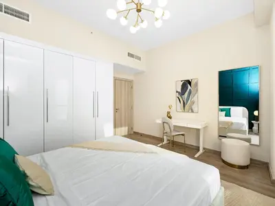 a white bedroom with a bed and a desk at Breathtaking Sea View and Dubai Eye 2BR in Dubai