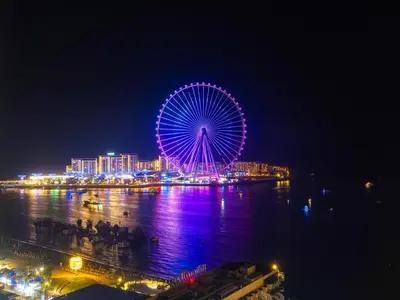a ferris wheel is lit up at night at Breathtaking Sea View and Dubai Eye 2BR in Dubai
