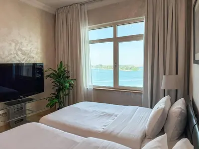 a hotel room with two beds and a window at Sea View Beachfront 3BR Apartment - Shoreline 6 in Dubai