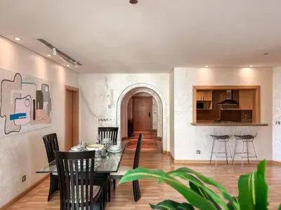 a dining room and kitchen with a table and chairs at Sea View Beachfront 3BR Apartment - Shoreline 6 in Dubai