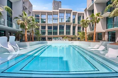 an empty swimming pool in front of a building at Modern Studio Elegant & Comfort in Dubai