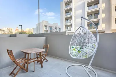 a patio with a table and chairs on a balcony at Modern Studio Elegant & Comfort in Dubai
