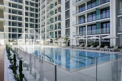 a swimming pool in front of a building at Bloomfields Cozy Stu Binghatti Azure in Dubai