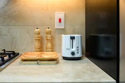 a coffee maker sitting on a counter next to a toaster at Luxurious 3BR with a pool table at Marina Walk in Dubai