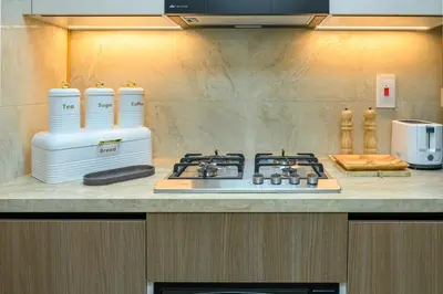 a kitchen counter with a stove and a blender at Luxurious 3BR with a pool table at Marina Walk in Dubai