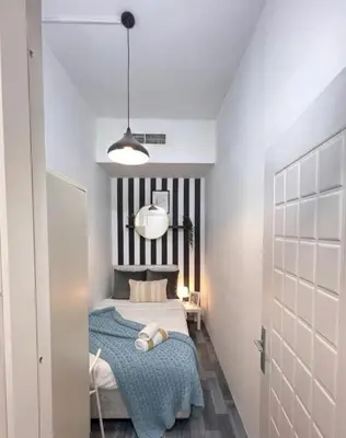a bedroom with a bed with a black and white headboard at Serene Stay In Barsha Heights Tecom in Dubai