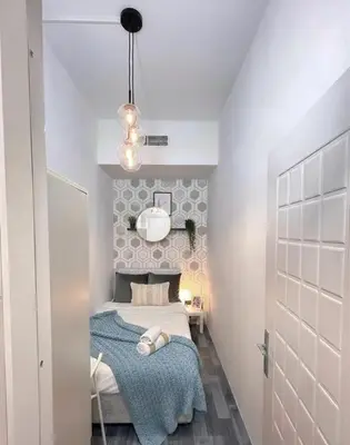a small bedroom with a bed and a mirror at Dream room Partition In Barsha Heights Tecom in Dubai