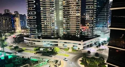a view of a building in a city at night at Dream room Partition In Barsha Heights Tecom in Dubai