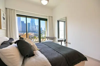 a bedroom with a bed and a large window at Full Burj Khalifa View, 3min Walk to Dubai Mall in Dubai