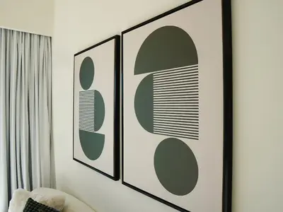 a living room with three framed pictures on the wall at Stylish-2BR, Burj Royale, 3 min walk to Dubai Mall in Dubai
