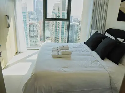 a large bed in a room with a large window at Stylish-2BR, Burj Royale, 3 min walk to Dubai Mall in Dubai