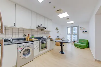 a kitchen with a sink and a washing machine at Boho Style 2BHK Apartment With Sea View Next to Tram Station in Dubai