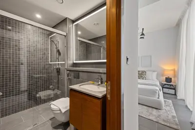 a bathroom with a sink and a shower and a toilet at Modern Apartment with Balcony and Pool Access in Dubai