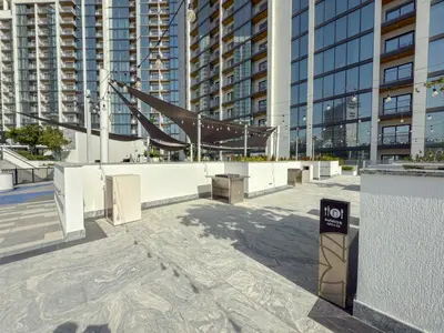 a walkway in a city with tall buildings at Modern Apartment with Balcony and Pool Access in Dubai