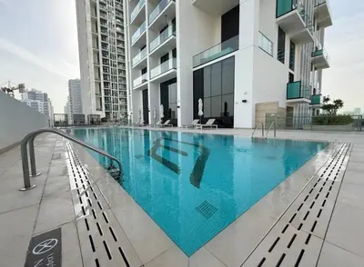 a swimming pool on the roof of a building at High Rise Studio Pool Gym Binghatti Gardenia JVC in Dubai