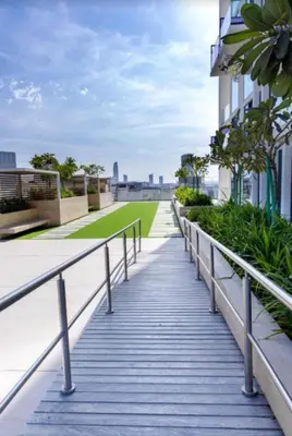 a walkway on the roof of a building at High Rise Studio Pool Gym Binghatti Gardenia JVC in Dubai