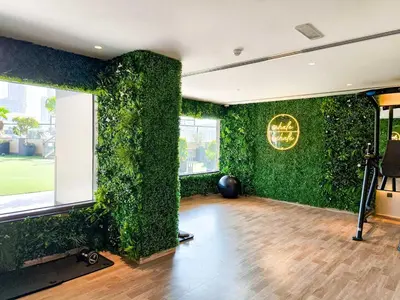 a living room with a green wall at Cozy Spacious Studio in Downtown with Burj Khalifa View in Dubai