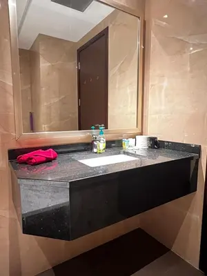 a bathroom with a sink and a mirror at Cozy Spacious Studio in Downtown with Burj Khalifa View in Dubai