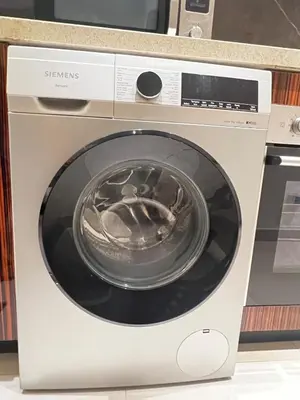 a washing machine with a bowl on top of it at Cozy Spacious Studio in Downtown with Burj Khalifa View in Dubai