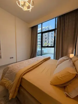 a bedroom with a large bed with a large window at RIVIERA HOME ESCAPE 2BHK pool Gym in Dubai