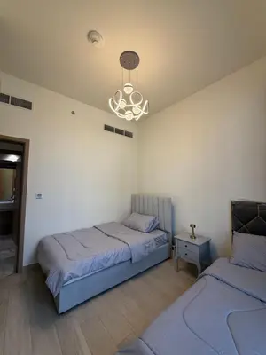 a bedroom with two beds and a chandelier at RIVIERA HOME ESCAPE 2BHK pool Gym in Dubai