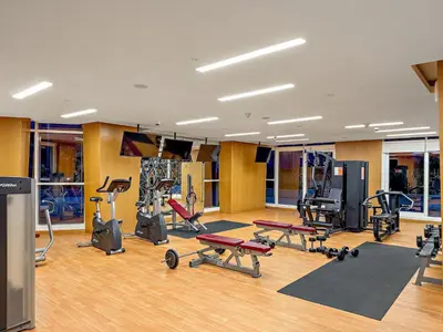 a gym with several different types of exercise equipment at Spacious 1BR with Huge Terrace in Dubai