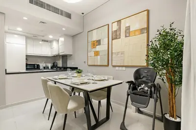 a kitchen and dining room with a table and chairs at Spacious 1BR with Huge Terrace in Dubai