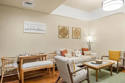 a living room with a couch and a table and chairs at FIRST CLASS VILLA Modern Comfort & Style in Dubai