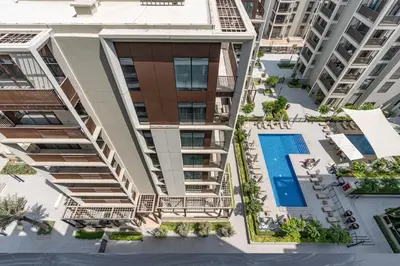 an overhead view of an apartment building with a swimming pool at Premium Creek Home Steps from the Lagoon in Dubai