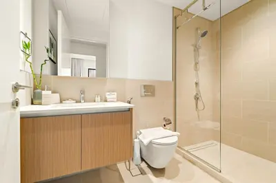 a bathroom with a shower and a toilet and a sink at FIRST CLASS 1BR Creek Beach , Relaxing Vibes in Dubai