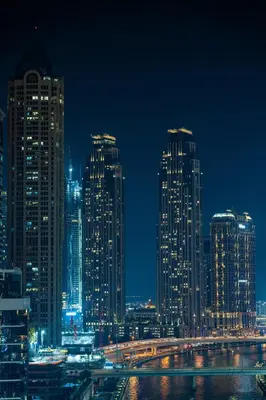 a city skyline at night with tall buildings at Business Bay 1BR Burj Khalifa&Canal Views,3Balcony in Dubai