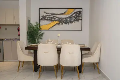 a dining room with a table and white chairs at Business Bay 1BR Burj Khalifa&Canal Views,3Balcony in Dubai