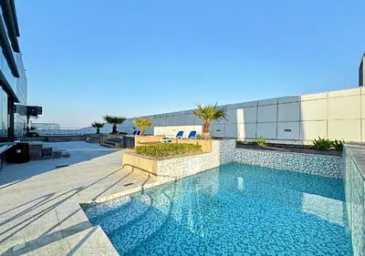 a swimming pool on the side of a building at Cosmos Living Delightful Studio in Dubai