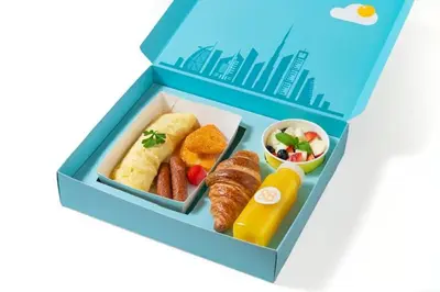 a model of a lunch box with food in it at Cosmos Living Delightful Studio in Dubai
