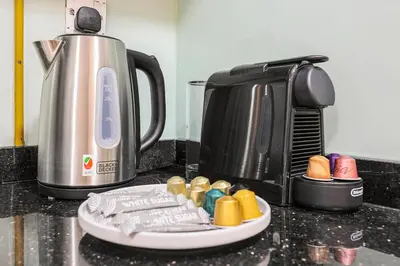 a counter with a plate of food next to a coffee maker at FIRST CLASS Studio Stylish & Cozy JVC Escape in Dubai