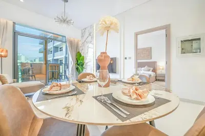 a dining room with a table with food on it at EasyGo - Modern 1BR with Balcony & Amenities in Arjan in Dubai