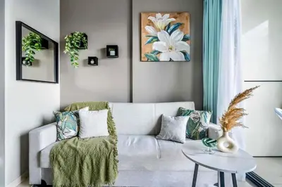a living room with a couch and a table at Cosy flat in the heart of Dubai in Dubai