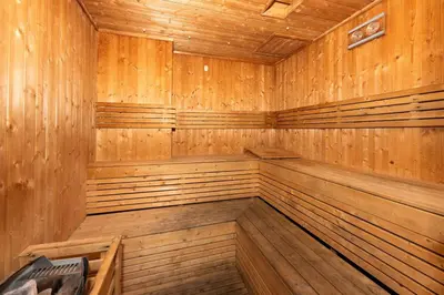 an empty wooden sauna with wood paneling at Chic Studio Near Burj Khalifa in Dubai