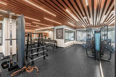 a gym with several treadmills and machines in it at Chic Studio Near Burj Khalifa in Dubai