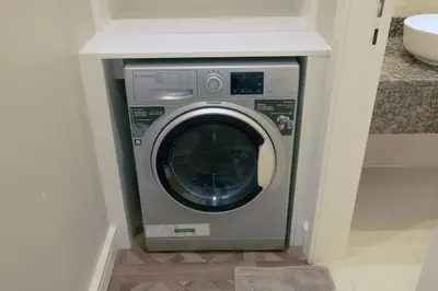 a washer and dryer in a corner of a room at Full Sea View Luxury Large 1 BR in JBR in Dubai