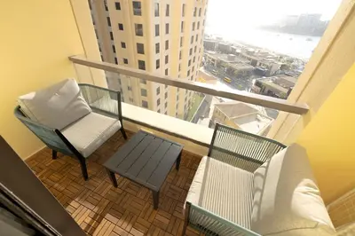 a balcony with two chairs and a table at Full Sea View Luxury Large 1 BR in JBR in Dubai