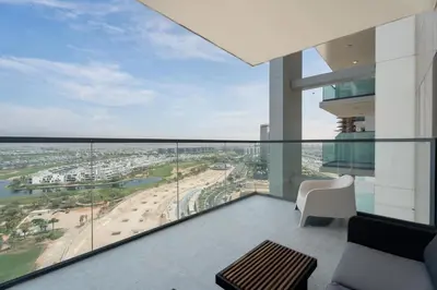 a balcony with a view of a beach at Gala Guests - Golf Gate Residences with Panoramic Golf Views in Dubai