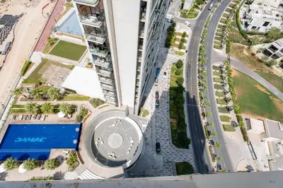 an aerial view of a building in a city at Gala Guests - Golf Gate Residences with Panoramic Golf Views in Dubai