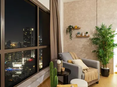 a living room with a large window with a city view at Beachfront 2BR Dubai Eye & Sea View Beach Access in Dubai