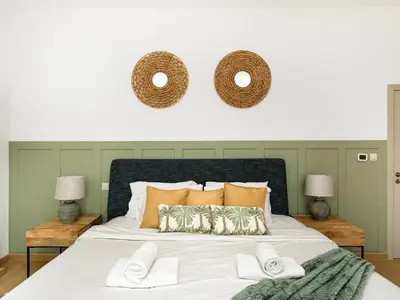 a bedroom with a large bed with two mirrors on the wall at Beachfront 2BR Dubai Eye & Sea View Beach Access in Dubai
